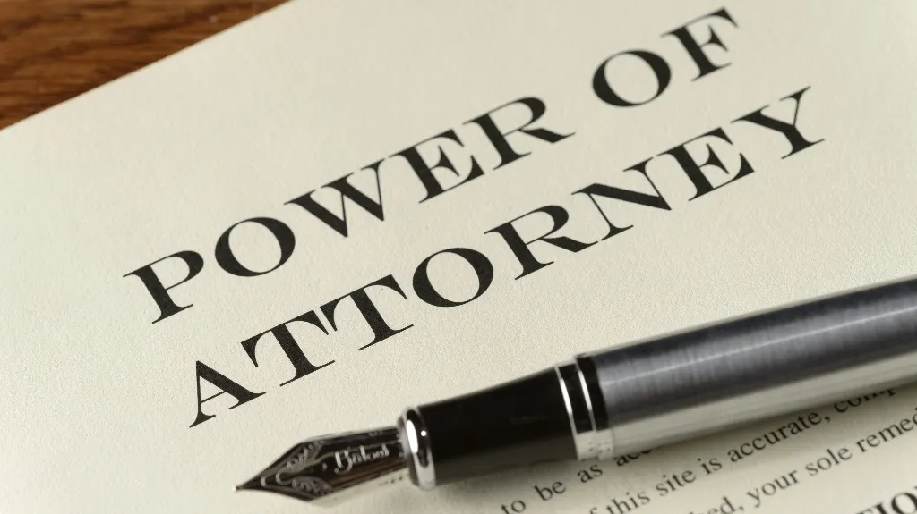 Close-up of a Power of Attorney document with a silver fountain pen resting on it.