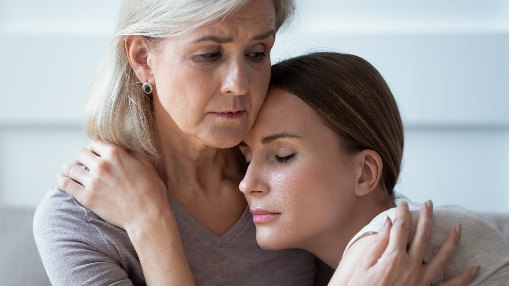 Elderly woman looking at a younger woman with suspicion