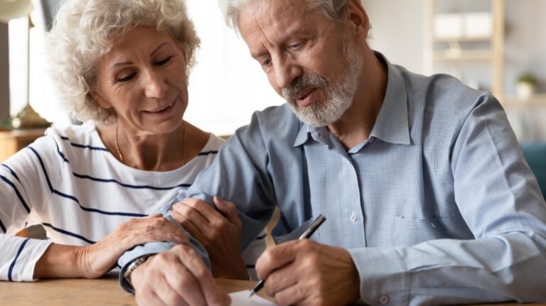 Elderly couple filling out paperwork