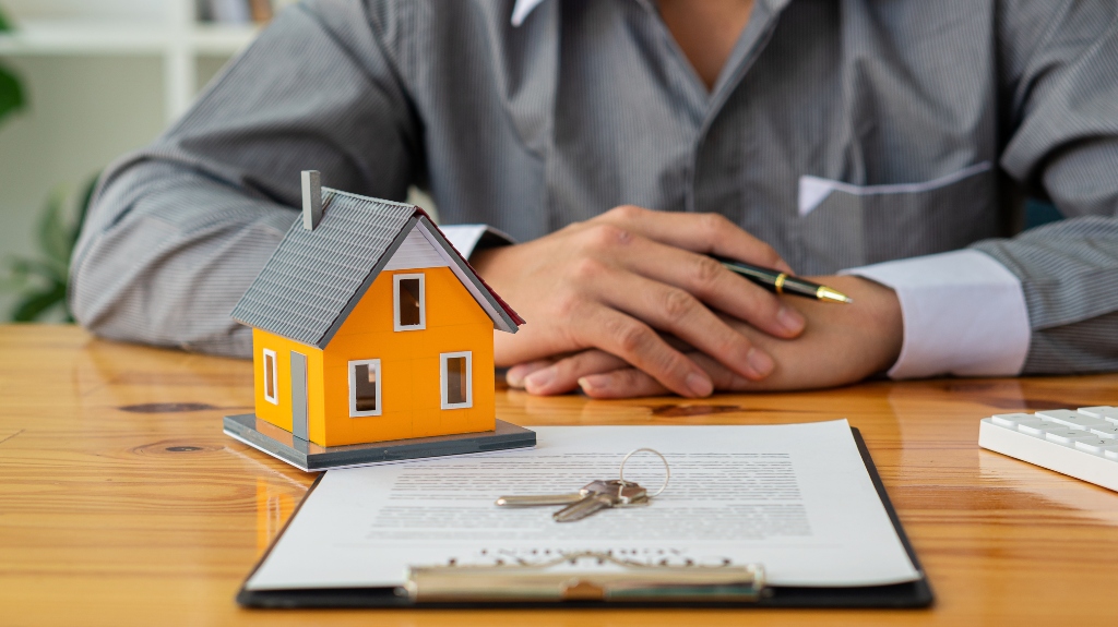estate paper work with house and keys