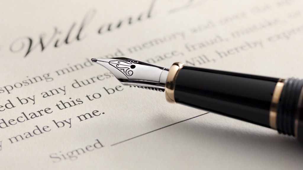 person in Louisiana about to sign the will with a pen