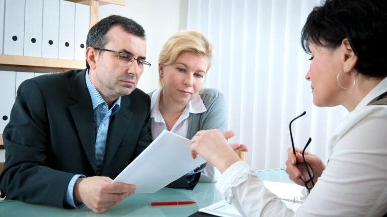 mid adult couple meeting with lawyer