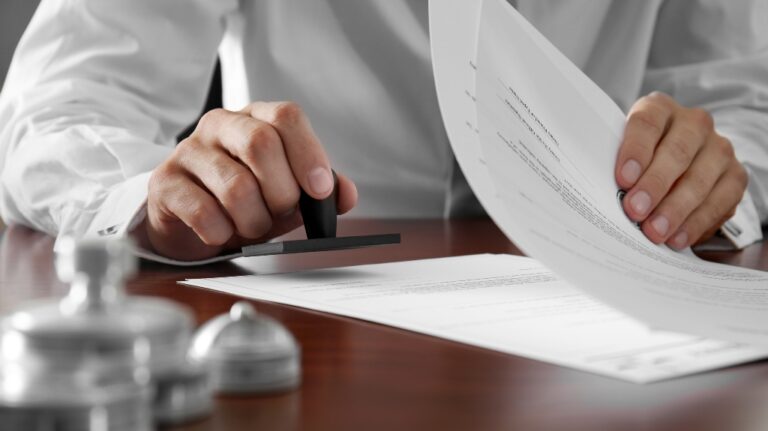 notary puts a stamp on the documents