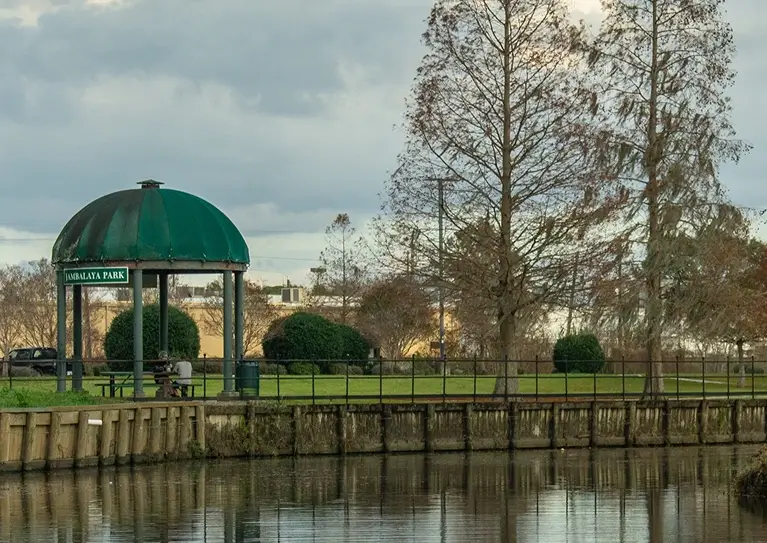 A serene canal scene featuring a green dome and an elegant bridge arching over the water