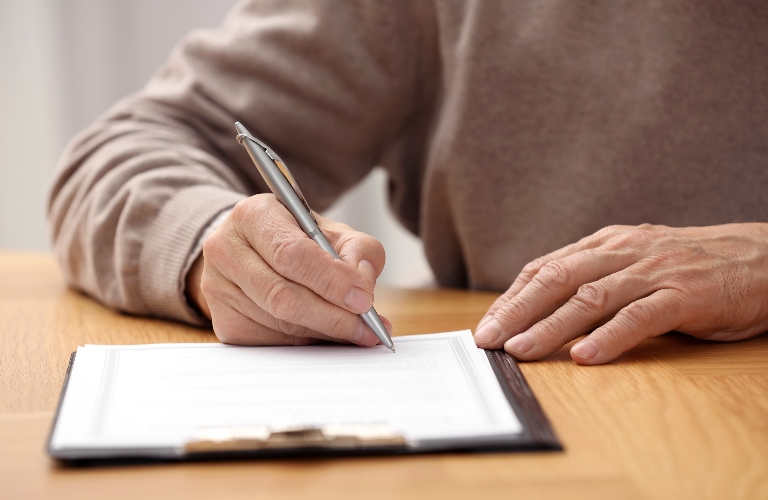 Senior man signing Last Will