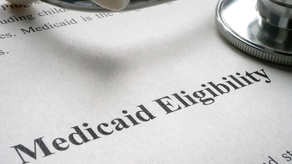 Close-up of a document titled "Medicaid Eligibility" with a stethoscope resting on the paper.