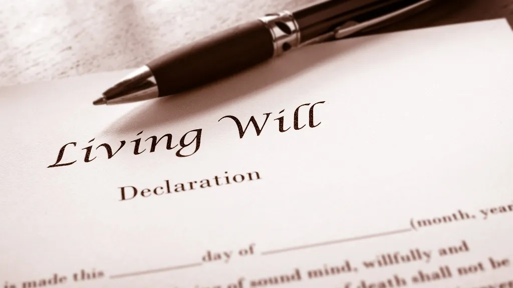 Close-up of a living will declaration document with a black pen resting on top.