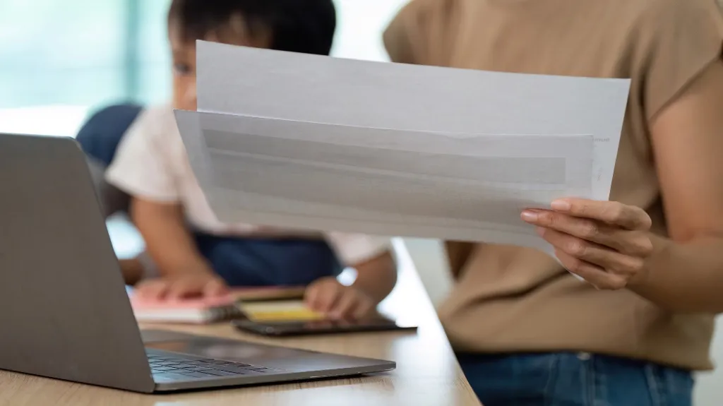 parent reviewing paperwork with child